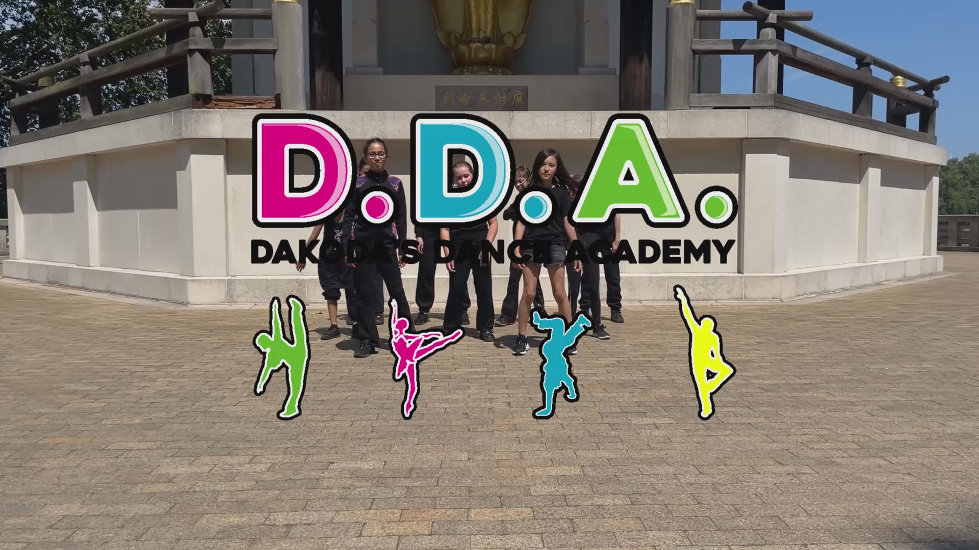Group of children in matching black and colourful outfits dancing hip hop outdoors, representing a street dance and breakdance competition team from a performing arts school in Central London
